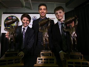 Ethan Edstrom, left. Fabio Denardis, centre, and Quinn Sweetzer pose with their Wayne Gretzky Award trophies during the kickoff of Minor Hockey Week at Rexall Place in Edmonton, Alta., on Jan.6. (Perry Mah, Edmotnon Sun)