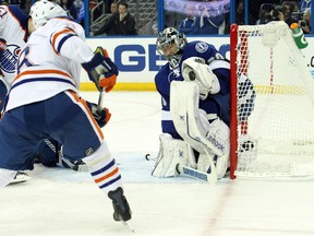 Lightning goal Ben Bishops stops a shot from Oilers centre Derek Roy Thursday in Tampa Bay. (USA TODAY SPORTS)