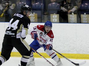 Kingston Voyageurs’ Joey Beaudoin tries to pass the puck past the Trenton Golden Hawks’ Matt Pizzo during Ontario Junior Hockey League action at the Invista Centre on Thursday night. The Golden Hawks scored four goals in less than six minutes in the second period en route to a 5-1 victory. (Ian MacAlpine/The Whig-Standard)