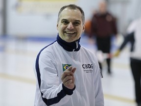 Skip Marcelo Mello of the Brazilian national team indicates how close his shot was during the Manitoba Open bonspiel at the Fort Garry Curling Club in Winnipeg, Man., on Thu., Jan. 15, 2014. Kevin King/Winnipeg Sun/QMI Agency