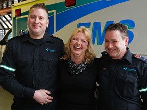 Debbie Robertson, centre, was saved by a clot-busting drug last September. On her left is Paramedic Randy Brosnikoff and EMT Chris Cowling is on the right. Edmonton Sun photo
