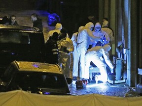 Belgian police inspect the entrance of an apartment in central Verviers, a town between Liege and the German border, in the east of Belgium January 15, 2015. At least two people were killed when Belgian counter-terrorist police raided an apartment used by suspected Islamist radicals on Thursday, local media said, describing a coordinated, national operation related to last week's attacks in Paris. Judiciary officials confirmed only that a counter-terrorism operation took place in Verviers.  REUTERS/Francois Lenoir