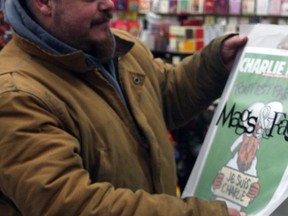 Gatineau man Tim Goulet lined up at 10:30 p.m. Thursday to be first in line to buy Charlie Hebdo magazine at Mags and Fags on Elgin St. when the store opened Friday at 7 a.m.
Corey Larocque / Ottawa Sun