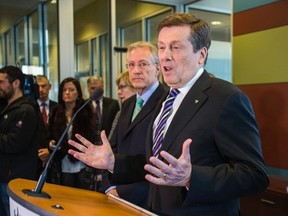 Mayor John Tory speaks about the TCHC task force as Senator Art Eggleton listens Friday, Jan. 16, 2015. (Ernest Doroszuk/Toronto Sun)