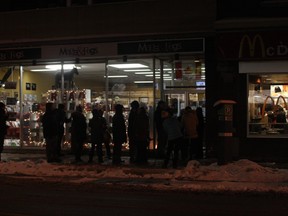 A line formed outside the Mags and Fags shop on Elgin St., Friday morning where the specialty newsstand had five copies of this week's Charlie Hebdo magazine for sale. Corey Larocque / Ottawa Sun