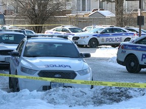 Up to 30 emergency police vehicles blocked off a 14 story apartment building at 2975 Albion Road in Ottawa Friday Jan 16,  2015. Ottawa Police and swat team members arrested seven people on the scene after a home invasion. One man was taken to an ambulance on the scene.   
Tony Caldwell/Ottawa Sun/QMI Agency