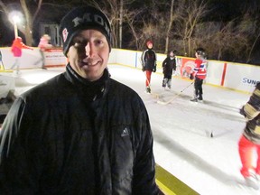 Rob Plamondon stands by his backyard rink, built to look like the ice and boards in a hockey arena. The Sarnia man said he worked with his children since August on the project. TYLER KULA/ THE OBSERER/ QMI AGENCY