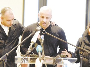 Malek Merabet, centre, brother of slain French police officer Ahmed Merabet, speaks during a press conference in the Livry-Gargan suburb of Paris on Jan. 10, with Ahmed?s brother-in-law Lotfi Mabrouk, left, and Ahmed?s partner Morgane. (Martin Bureau, AFP Photo)