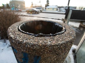 A City of Edmonton concrete garbage can is seen at a bus stop along 99 Street north of 76 Avenue in Edmonton, Alta., on Friday, Jan. 16, 2015. Council is debating the use of the concrete cans versus plastic ones. Ian Kucerak/Edmonton Sun
