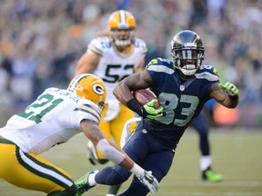 Seahawks wide receiver Ricardo Lockette (right) avoids Packers free safety Ha Ha Clinton-Dix (left) and later scores a touchdown during first half NFL action in Seatle on Sept. 4, 2014. (Steven Bisig/USA TODAY Sports)