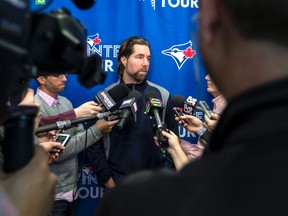 Knuckleball pitcher R.A. Dickey casually chats with a group of reporters during the Toronto Blue Jays’ annual winter caravan stop at the Rogers Centre on Wednesday. (CRAIG ROBERTSON, Toronto Sun)