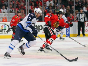 Jan 16, 2015; Chicago, IL, USA; Winnipeg Jets left wing Evander Kane (9) skates past Chicago Blackhawks left wing Teuvo Teravainen (86) during the second period at the United Center. Mandatory Credit: Dennis Wierzbicki-USA TODAY Sports