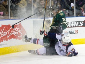 London Knights forward Max Domi gets tied up in Windsor Spitfires defenceman Graeme Brown?s legs as they slide into the boards during the third period of their OHL game at Budweiser Gardens on Friday night. The Knights won 5-2. (CRAIG GLOVER, The London Free Press)