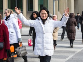 Helena Liu crosses the busy intersection at Yonge and Bloor Sts. on Jan. 15, 2015. (Craig Robertson/Toronto Sun)