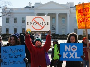 Activists hold a rally against government approval of the planned Keystone XL oil pipeline, in front of the White House in Washington January 10, 2015. The pipeline cleared two hurdles on Friday, setting up a showdown between Congress and President Barack Obama who has raised new questions about the project after more than six years of review.  REUTERS/Jonathan Ernst