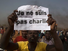 A man holds a sign during a protest against Niger President Mahamadou Issoufou's attendance last week at a Paris rally in support of French satirical weekly Charlie Hebdo, which featured a cartoon of the Prophet Mohammad as the cover of its first edition since an attack by Islamist gunmen, in Niamey January 17, 2015. The sign reads as "I am not Charlie". REUTERS/Tagaza Djibo