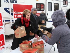 Ontario Premier Kathleen Wynne, left, and Sudbury Liberal candidate Glenn Thibeault hand out hot chocolate and coffee to supporters during the launch of the Team Thibeault RV at Science North in Sudbury, ON. on Saturday. JOHN LAPPA/THE SUDBURY STAR/QMI AGENCY