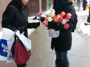 Paloma (her last name not given) was one of several Muslim volunteers who handed out roses with uplifting quotes to those walking by on Rideau Street on Saturday, January 17, 2014.
Keaton Robbins/Ottawa Sun/QMI AGENCY