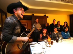 Brett Kissel meet and sings for the winners of the Edmonton Sun and CISN Radio winners at Ruth Chris in Edmonton, AB on Tuesday, December 16, 2014. The media outlets as partners with the Edmonton Singing Christmas Tree ran a promotion for a chance to have dinner with Kissel. Perry Mah/Edmonton Sun/QMI Agency