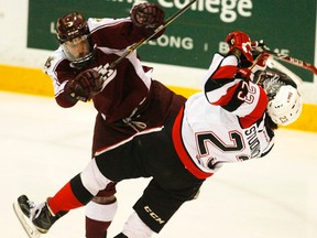 Peterborough Petes' Cameron Lizotte levels Ottawa 67's Sam Studnicka during first period OHL action on Saturday, Jan. 17, 2015 at the Memorial Centre in Peterborough. Clifford Skarstedt/Peterborough Examiner/QMI Agency