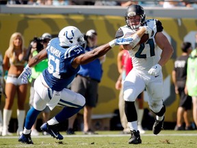 JACKSONVILLE, FL - SEPTEMBER 21: Toby Gerhart #21 of the Jacksonville Jaguars runs with the ball against Henoc Muamba #51 of the Indianapolis Colts during the second half of the game at EverBank Field on September 21, 2014 in Jacksonville, Florida.  Rob Foldy/Getty Images/AFP