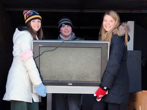 From left, Maryann Herring, Nathan Raby, and Quinn Tureski are grade 10 students at La Salle Secondary School in Kingston, Ont. on Saturday January 17, 2015. The trio and their parents are collecting E-waste to help fund their trip to Nicaragua where they will teach English to young students.  Steph Crosier/Kingston Whig-Standard/QMI Agency