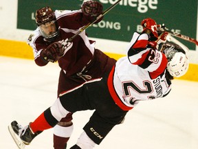 Peterborough Petes' Cameron Lizotte levels Ottawa 67's Sam Studnicka during first period OHL action on Saturday, Jan. 17, 2015 at the Memorial Centre in Peterborough. Clifford Skarstedt/Peterborough Examiner/QMI Agency