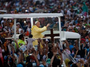 Pope Francis waves from the popemobile after leading a Mass at Rizal Park in Manila January 18, 2015. Huge crowds converged on a Manila park on Sunday to see Pope Francis wrap up his Asian trip with an outdoor Mass expected to draw one of the largest crowds in Philippine history.  REUTERS/Erik De Castro