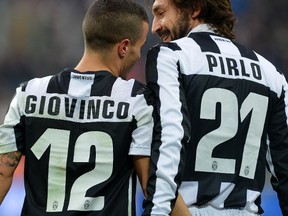 Juventus' Sebastian Giovinco (L) celebrates after scoring against Siena with Andrea Pirlo on February 24, 2013 during a Serie A football match at the Juventus stadium in Turin. AFP PHOTO / ALBERTO LINGRIA