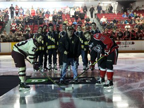 Ernie Beaupre, grandfather of injured Smiths Falls Bears player Neil Doef, drops the puck during a ceremonial faceoff before Sunday's game between the Ottawa 67's and Peterborough Petes at TD Place. Doef was injured in December during a game in Saskatchewan, suffering a serious spinal cord injury. The Doef Strong movement has since raised over $100,000 for the player and his family and Sunday's game served as a fundraiser to support the cause. (Chris Hofley/Ottawa Sun)
