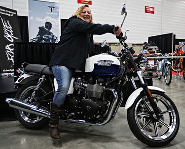 Margaret Kennedy reacts after winning a 2015 Triumph Bonneville Newchurch given away by the Edmonton Sun, CISN Country and Echo Cycle during the 2015 Motorcycle and ATV Show Edmonton at the Edmonton Expo Centre in Edmonton, Alta., on Sunday, Jan. 18, 2015. The limited edition motorcycle, of which only 25 will be sold in Canada, will ship to Kennedy later in the spring. Codie McLachlan/Edmonton Sun/QMI Agency