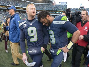 Seattle Seahawks punter Jon Ryan (9) and Russell Wilson (3) celebrate following the overtime victory over the Green Bay Packers in the NFC Championship Game at CenturyLink Field. The Seahawks defeated the Packers 28-22 in overtime. (Kirby Lee-USA TODAY Sports)