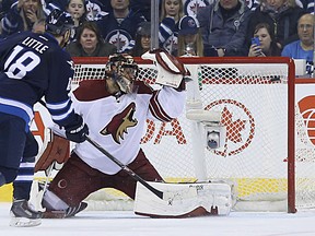 Winnipeg Jets centre Bryan Little beats Arizona Coyotes goaltender Mike Smith high glove side for the only goal of the shootout during NHL action at MTS Centre in Winnipeg, Man., on Sun., Jan. 18, 2015. Kevin King/Winnipeg Sun/QMI Agency