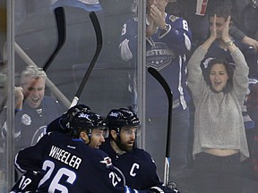 Winnipeg Jets forwards Blake Wheeler, Bryan Little and Andrew Ladd (from left) celebrate Little's goal against the Arizona Coyotes during NHL action at MTS Centre in Winnipeg, Man., on Sun., Jan. 18, 2015. Kevin King/Winnipeg Sun/QMI Agency