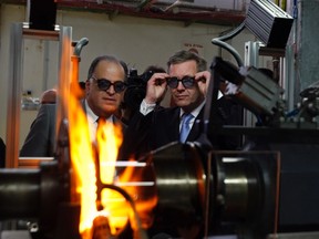 Germany's then-President Christian Wulff (R) and Avi Brenmiller, CEO of Siemens' solar receiver production plant, wear protective glasses during a visit to the plant in Beit Shemesh in this Nov. 29, 2010 file photo. REUTERS/Amir Cohen/Files