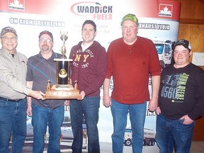 Sponsor Les Badder (Waddick Fuels) presents the Bob Richmond Memorial Trophy on Sunday, at the Sydenham Community Curling Club, to the Scott Lennox rink from Arthur as they defeated the Joe Griffore rink 9-4 in the final of the 30th annual All-Ontario Farmer's Bonspiel. Team members include, from left, Scott Lennox (skip), Darren Jones (vice), Doug Simpson (second) and Kevin Bryan (lead). The three-day bonspiel attracted 28 teams from across the province.