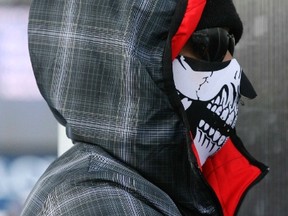 U.S. golfer Tiger Woods wears a mask as he attends the women's World Cup Super-G skiing race in Cortina D'Ampezzo January 19, 2015. Woods' girlfriend, Lindsey Vonn, became the most successful female in Alpine skiing World Cup history when she won a Super-G on Monday, her 63rd victory in the competition. (REUTERS)