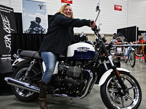 Margaret Kennedy is all smiles after winning a 2015 Special Edition Triumph Bonneville given away by the Edmonton Sun, CISN Country and Echo Cycle during the 2015 Motorcycle and ATV Show Edmonton at the Edmonton Expo Centre on Sunday.  (Codie McLachlan, Edmonton Sun)