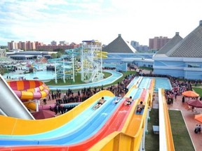 Spectators watch people use The Munsu Water Park in Pyongyang. Photo released October 16, 2013. Reuters/KCNA