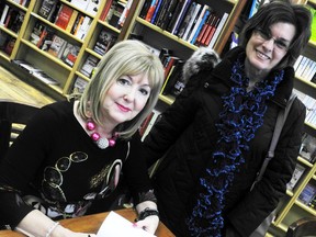 Author and grief counsellor Audrey Stringer signs a book for Ruth Ellerker, of Forest, at Sarnia's The Book Keeper Saturday. Stringer has released her latest book "Buddy's Life Lessons" written this time from the perspective of her late labrador retriever who died in early December. (BARBARA SIMPSON, The Observer)