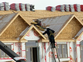 Workers get ready for a major roofing project as they were unloading about 160-170 bundles of shingles for a five-unit townhouse project off of Southdale Rd.
Mike Hensen/The London Free Press/QMI Agency