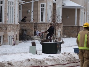 A bloody man is removed from a home by Kingston Police on Monday afternoon on Crossfield Avenue. (Elliot Ferguson/The Whig-Standard)