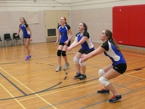 Members of the Mitchell DHS junior girls volleyball team get ready to defend a serve during H-P action last week. SUBMITTED