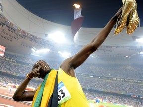 A photo taken on August 20, 2008 shows Jamaican sprinter Usain Bolt celebrating winning the men's 200m final at the "Bird's Nest" National Stadium during the 2008 Beijing Olympic Games. (AFP PHOTO / FABRICE COFFRINI)