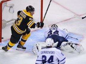 Boston Bruins' Brad Marchand (L) celebrates after his teammate Patrice Bergeron scored the overtime winner on Toronto Maple Leafs goalie James Reimer in Game 7 of their NHL Eastern Conference quarter-final hockey playoff series in Boston, Massachusetts May 13, 2013. REUTERS/Brian Snyder