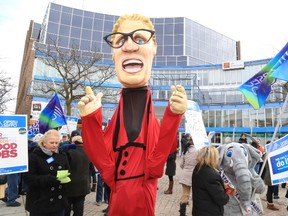 Jason Miller/The Intelligencer
A legion of local public service workers, including probation and court staff, picketed outside Century Place in Belleville Monday, to express their discontent over unsuccessful efforts to ink a new contract with the provincial government since last month. The protesters mocked Premier Kathleen Wynne with a giant costume depicting her image standing next to an elephant amongst the protesters (depicted with a costume as well).