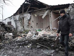 A man walks near a residential building, which according to locals was recently damaged by shelling, in Donetsk, eastern Ukraine January 19, 2015. REUTERS/Alexander Ermochenko