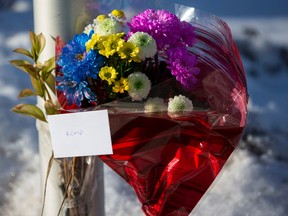 Fresh flowers are seen outside of the RCMP detachment in St. Albert, Alta., on Sunday, Jan. 18, 2015. (Ian Kucerak/Edmonton Sun)