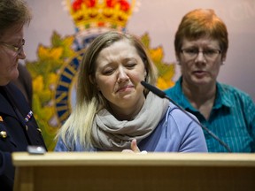 Surrounded by RCMP Commissioner Marianne Ryan (left) and Dawn Sephton (right), Const. David Wynn's wife Shelly MacInnis-Wynn speaks at a press conference in Edmonton, Alta., on Monday, Jan. 19, 2015. RCMP Const. David Wynn, is in hospital in grave condition after being shot by 34-year-old Shawn Maxwell Rehn in St. Albert on Jan. 17, 2015. Sephton is David Wynn's sister. MacInnis-Wynn said the family has said their last goodbyes to David. Ian Kucerak/Edmonton Sun