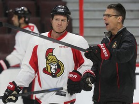 Ottawa Senators' Chris Neil talks to coach Dave Cameron during practice at the Canadian Tire Centre in Ottawa Monday, Jan. 19, 2015. (Tony Caldwell/Ottawa Sun/QMI Agency)